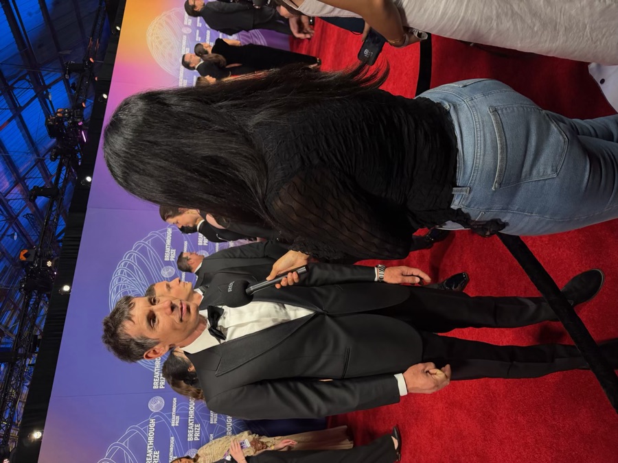 Sesha Dasari interviewing a guest on the red carpet