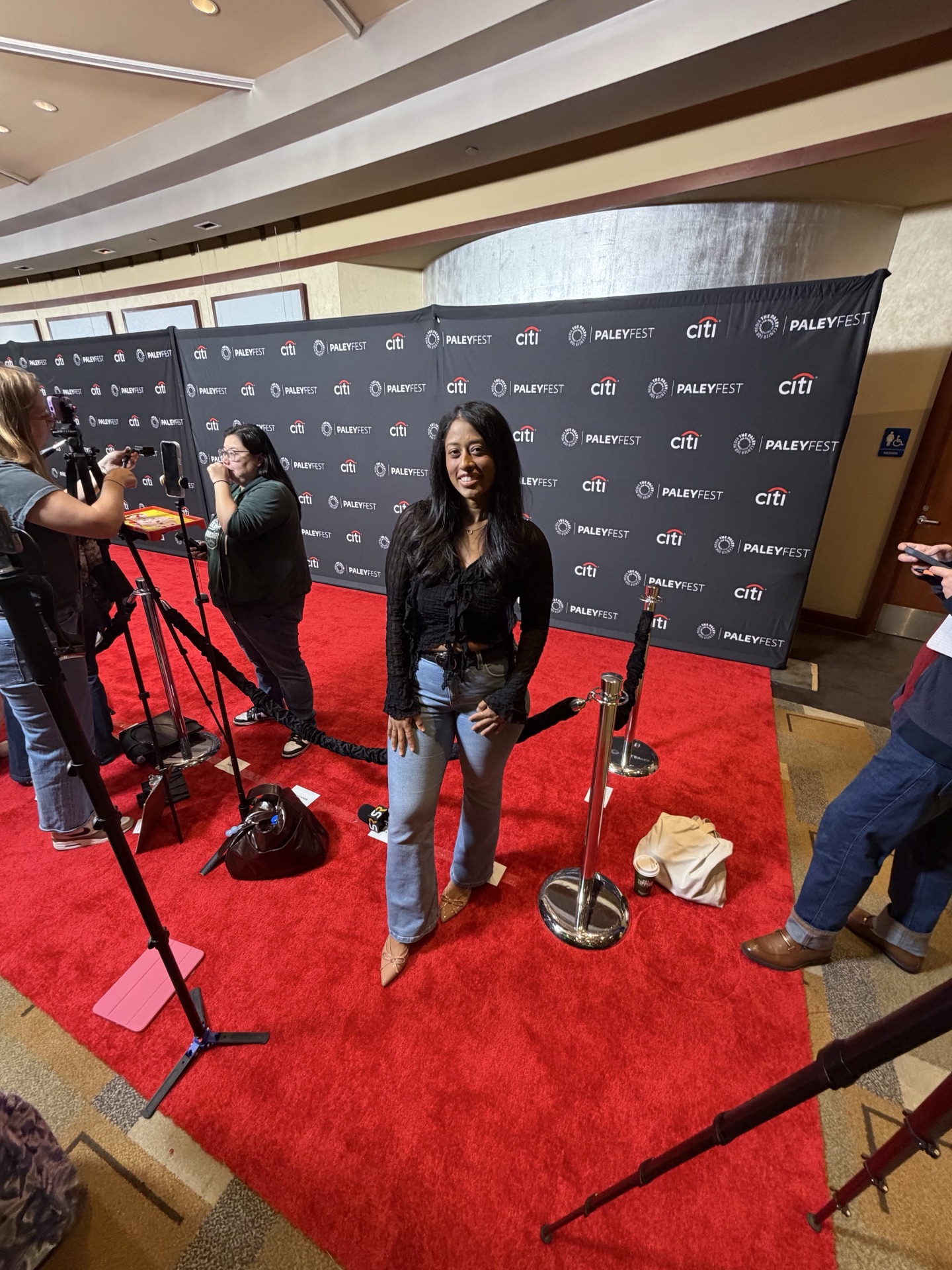 Sesha standing at a PaleyFest red-carpet media line